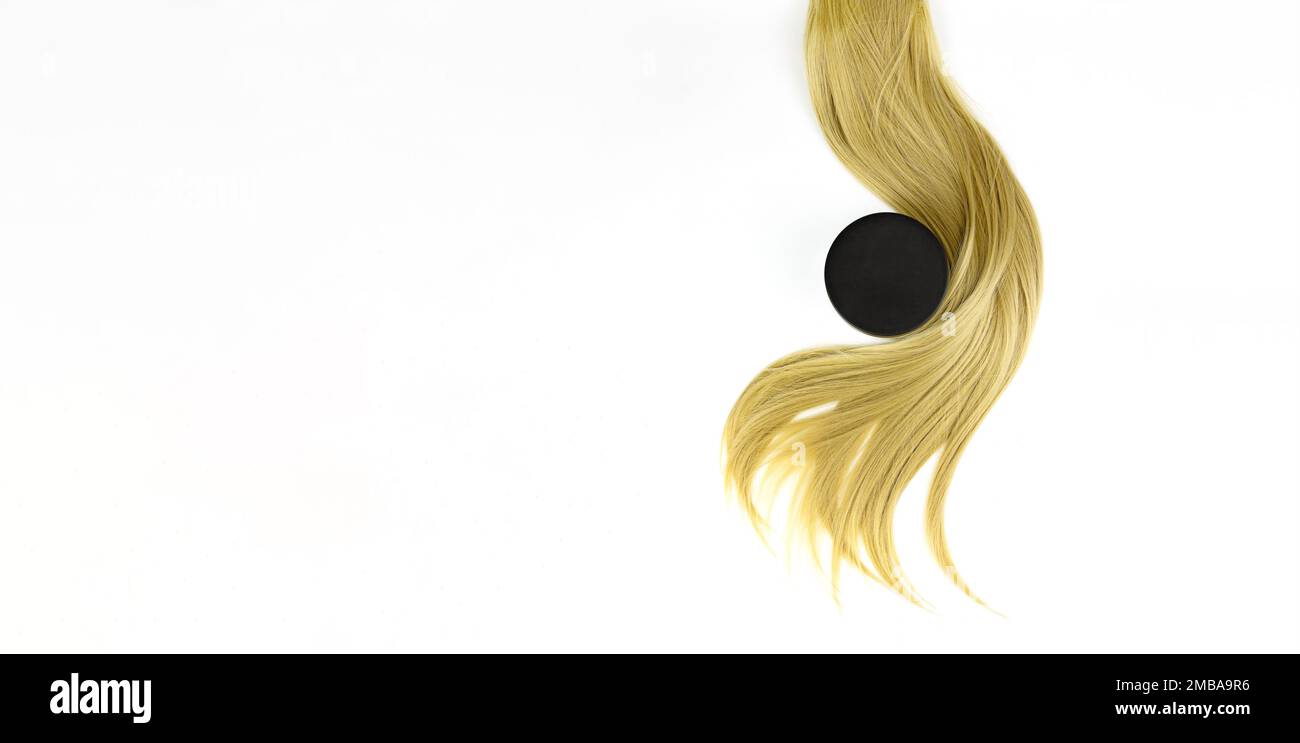 Different professional hairdresser tools balsam hair cream and strand of blonde hair on white background, flat lay. Hair care spa concept. Split Ends Stock Photo