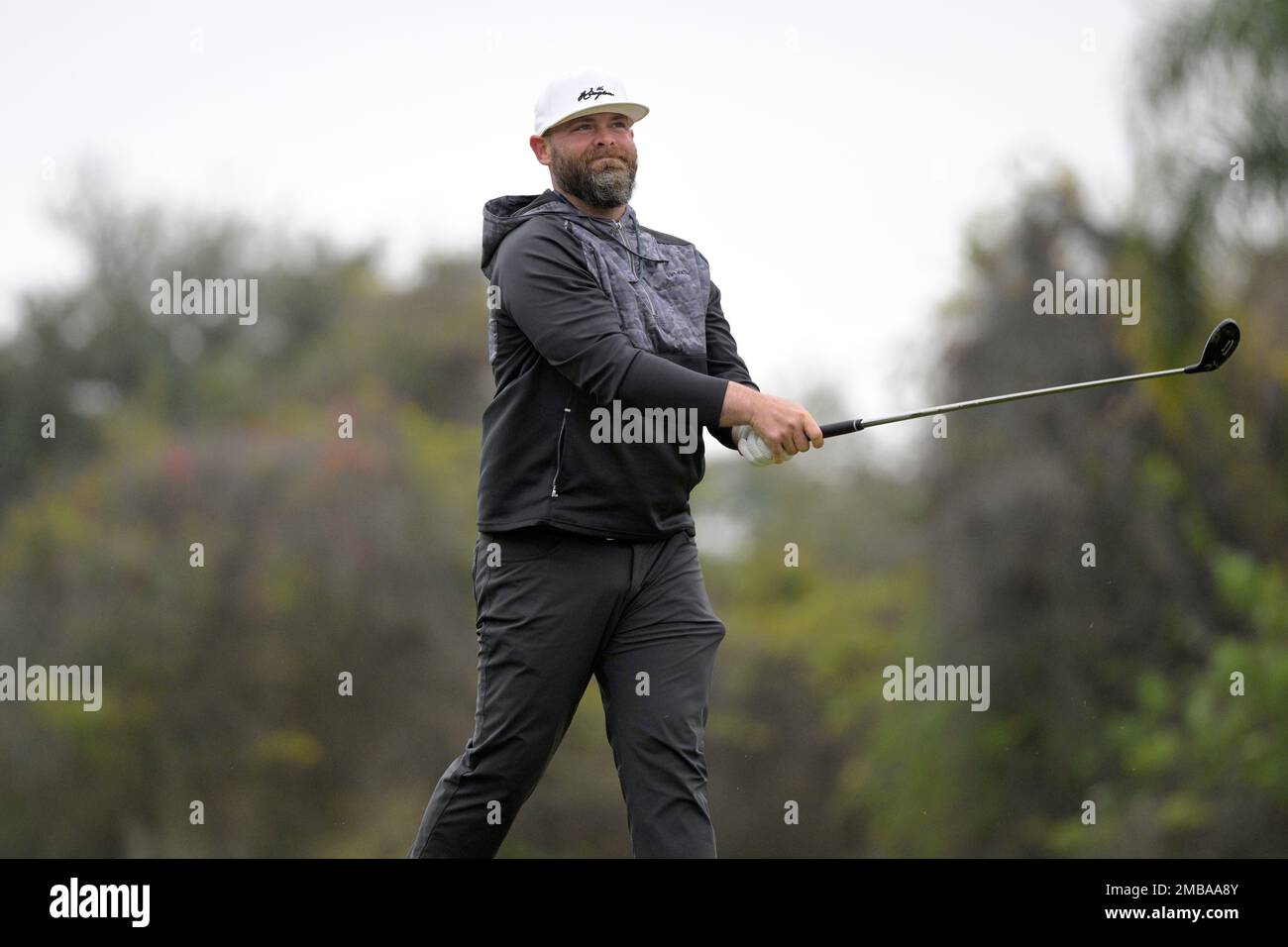 Former professional baseball player Brian McCann watches after hitting from  the ninth fairway during the third round of the Tournament of Champions  LPGA golf tournament, Saturday, Jan. 22, 2022, in Orlando, Fla. (