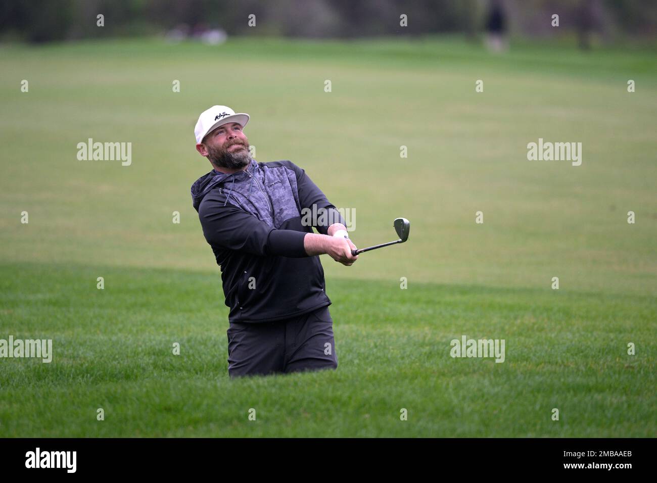 Former professional baseball player Brian McCann hits from a bunker along  the ninth fairway during the third round of the Tournament of Champions  LPGA golf tournament, Saturday, Jan. 22, 2022, in Orlando