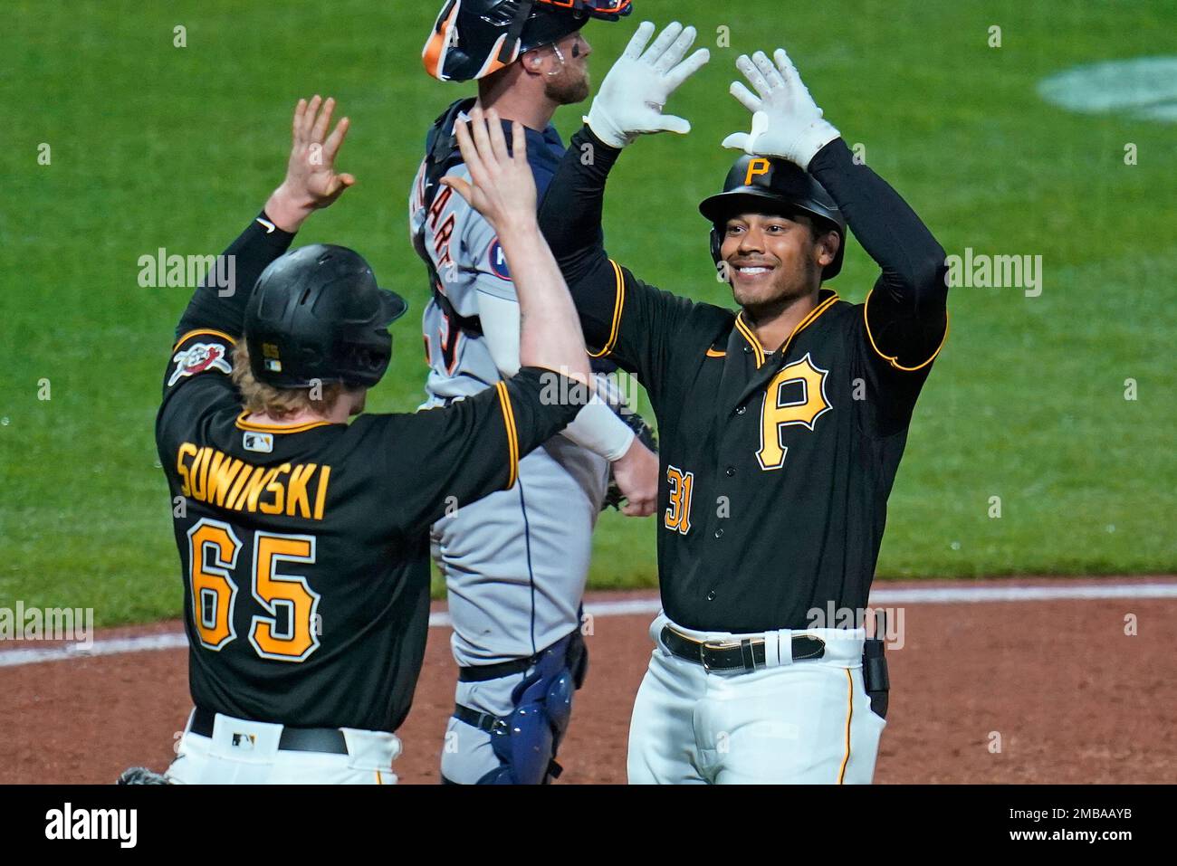 Pittsburgh Pirates' Cal Mitchell, right, is greeted by Jack