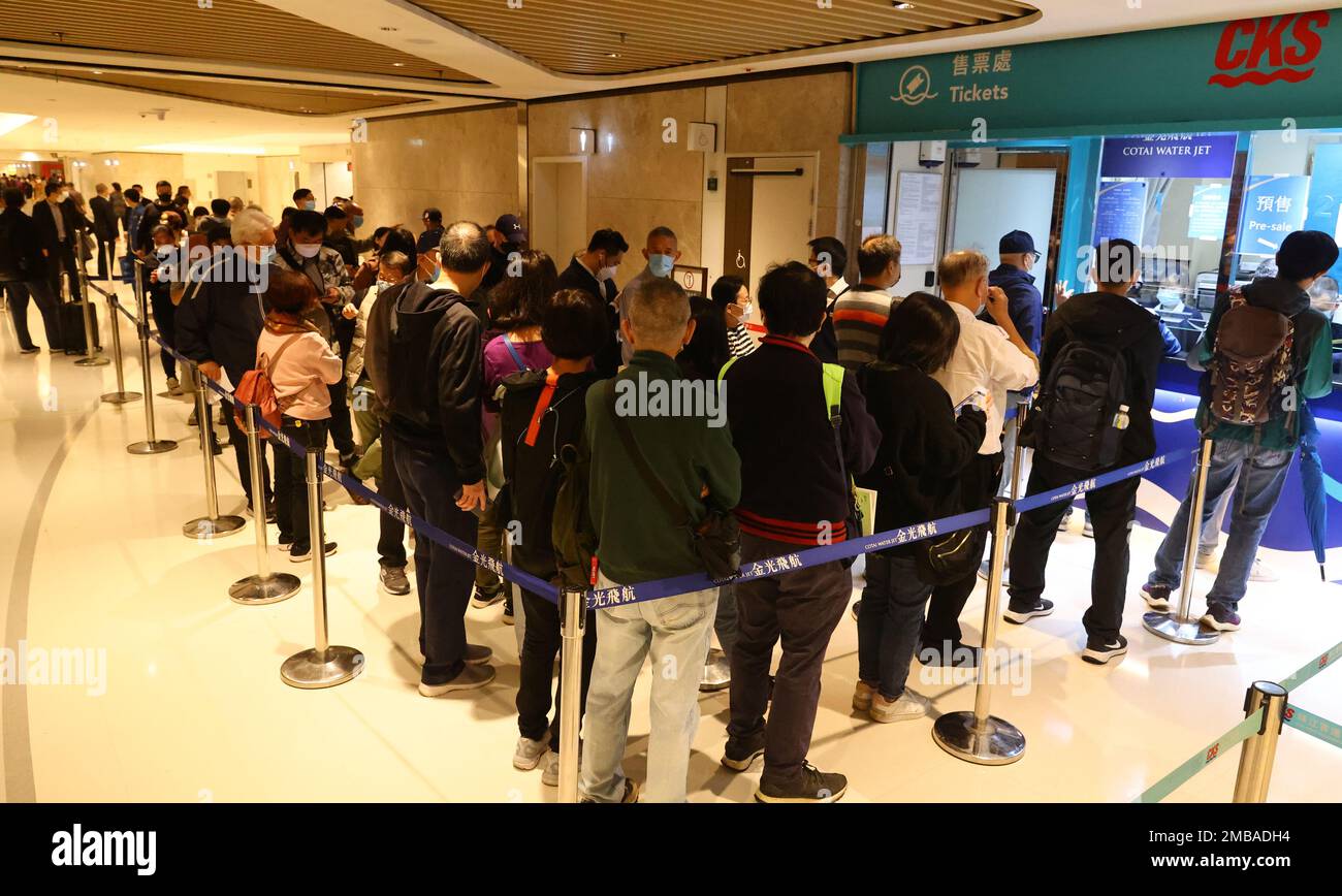 Macau ferry offer a free return ticket. Travellers queue for ticket at the Macau Ferry Terminal. Shun Tak Centre. 13JAN23. SCMP / Dickson Lee Stock Photo