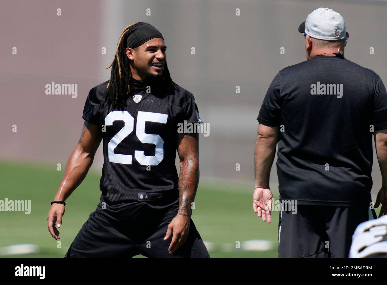 Raiders safety Trevon Moehrig (25) adjusts his head wrap during their NFL  training camp practic …