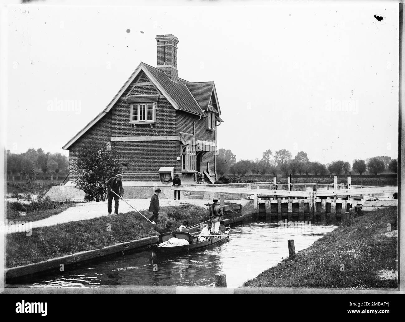 Lock Keeper's House, Goring, Goring-on-Thames, South Oxfordshire, 1885. The Lock Keeper's House and Goring Lock viewed from the south east with a Thames skiff in the lock in the foreground. Stock Photo