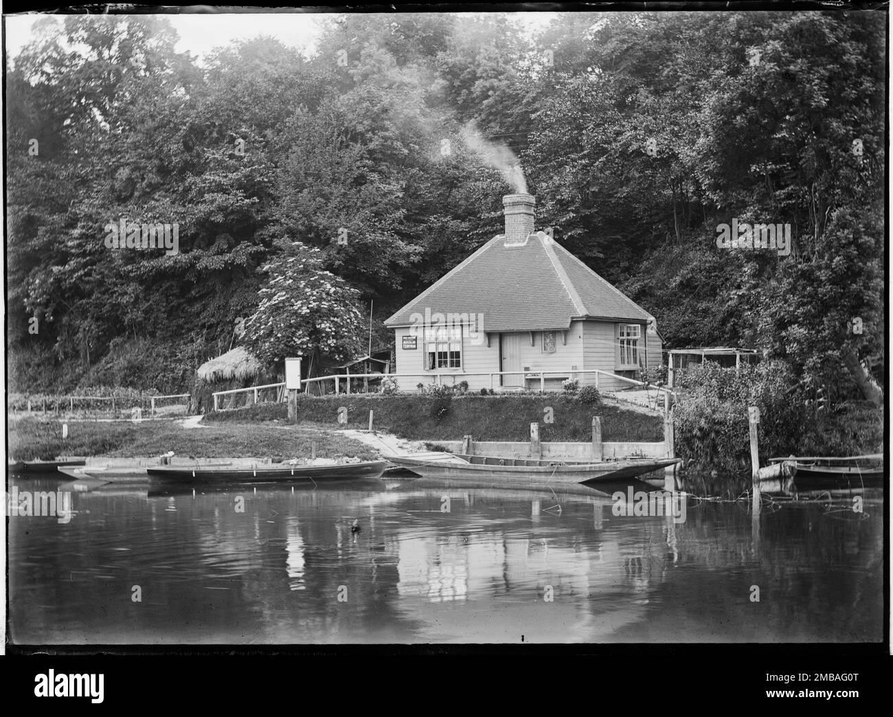 Roebuck Ferry Cottage, Tilehurst, Reading, 1885. Roebuck Ferry Cottage at Tilehurst viewed across the River Thames. The sign on the front of the cottage reads &quot;THAMES CONSERVANCY, JOSEPH COLLINS, FERRYMAN&quot;. Stock Photo