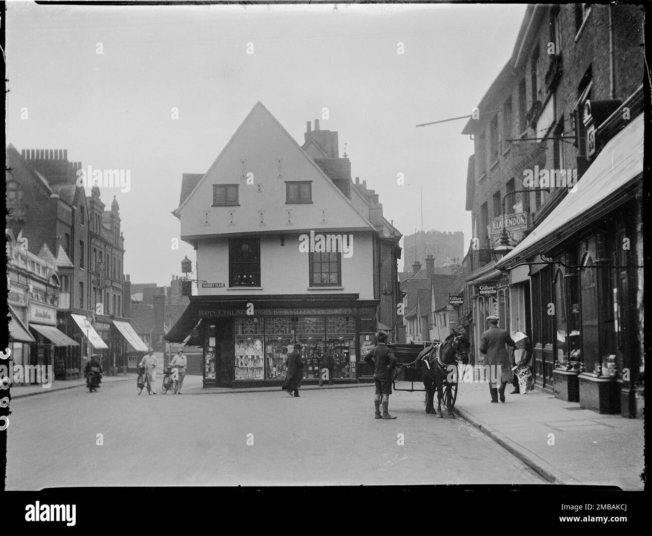 Market Place, St Albans, Hertfordshire, 1928. Looking south-west along the Market Place towards the north gable end of number 13 and the tower of St Albans Cathedral in the distance, with a few pedestrians and a horse drawn buggy in the foreground. Stock Photo