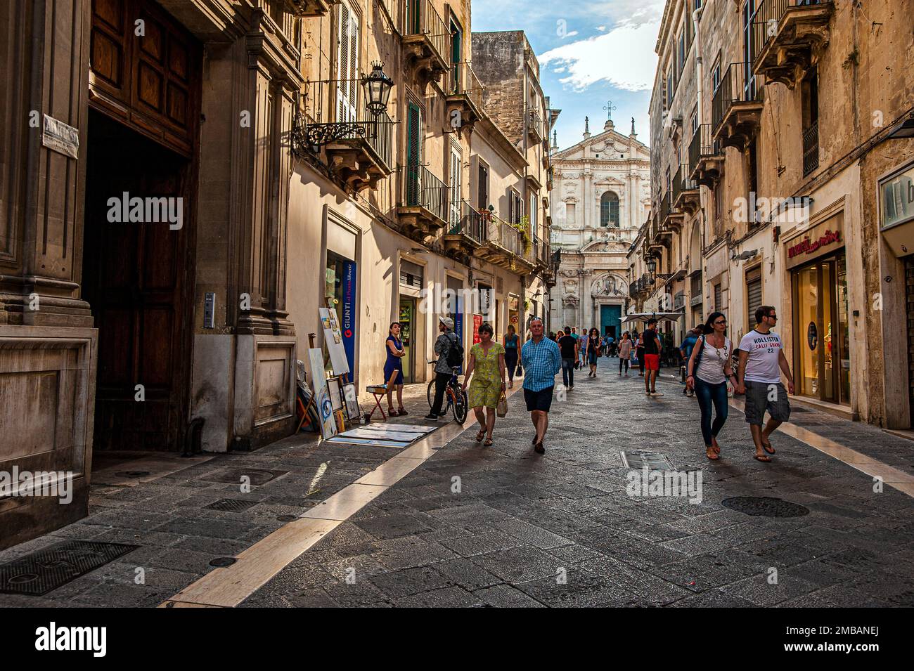 Italy Apulia Lecce Historic Center people in the stree and church of St. Irene Stock Photo