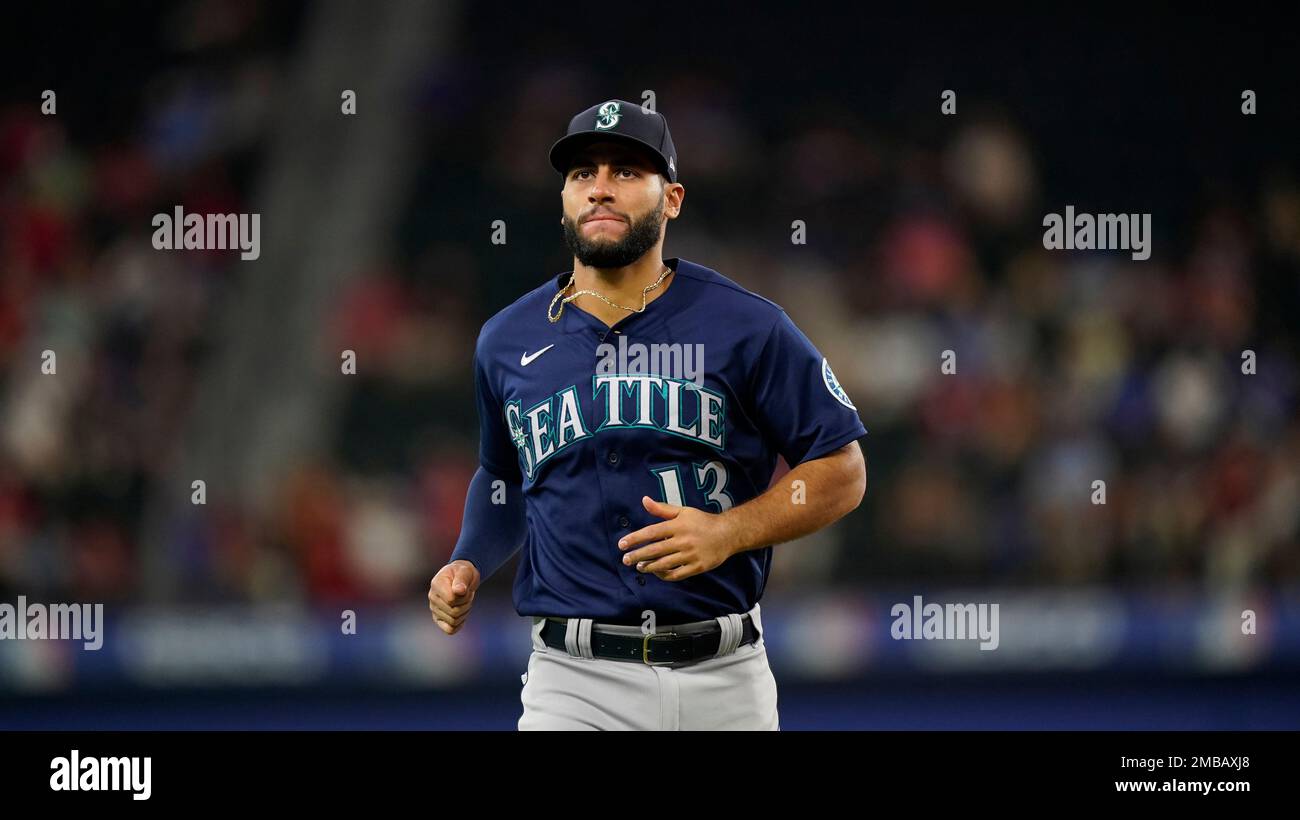 Seattle Mariners third baseman Abraham Toro, left, is late with