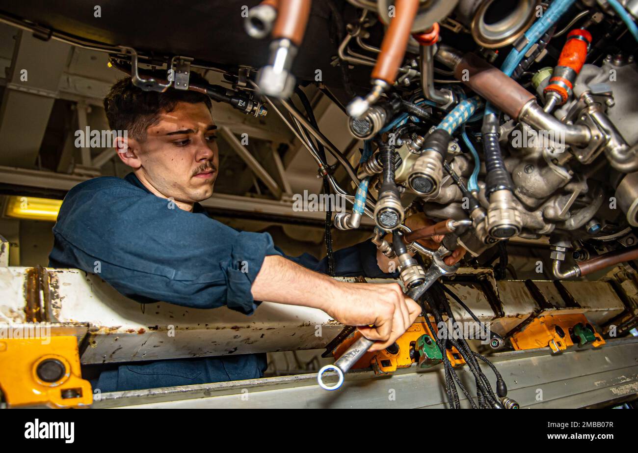 220614-N-PA358-1008 MEDITERRANEAN SEA (June 14, 2022) Airman Sterling Gibbs, from Goodyear, Arizona, tightens a bolt on a jet engine in the jet shop aboard USS Harry S. Truman (CVN 75), June 14, 2022. The Harry S. Truman Carrier Strike Group is on a scheduled deployment in the U.S. Naval Forces Europe area of operations, employed by U.S. Sixth Fleet to defend U.S., allied and partner interests. Stock Photo