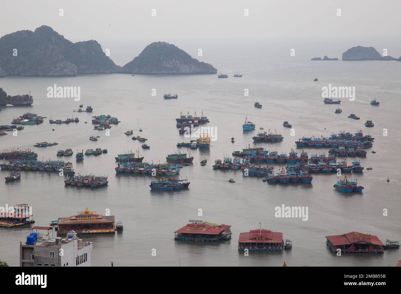 Cat Ba Island ( Halong bay ) View Over Landscape - boats float and floating structures  . Ha Long Bay , Vietnam Stock Photo