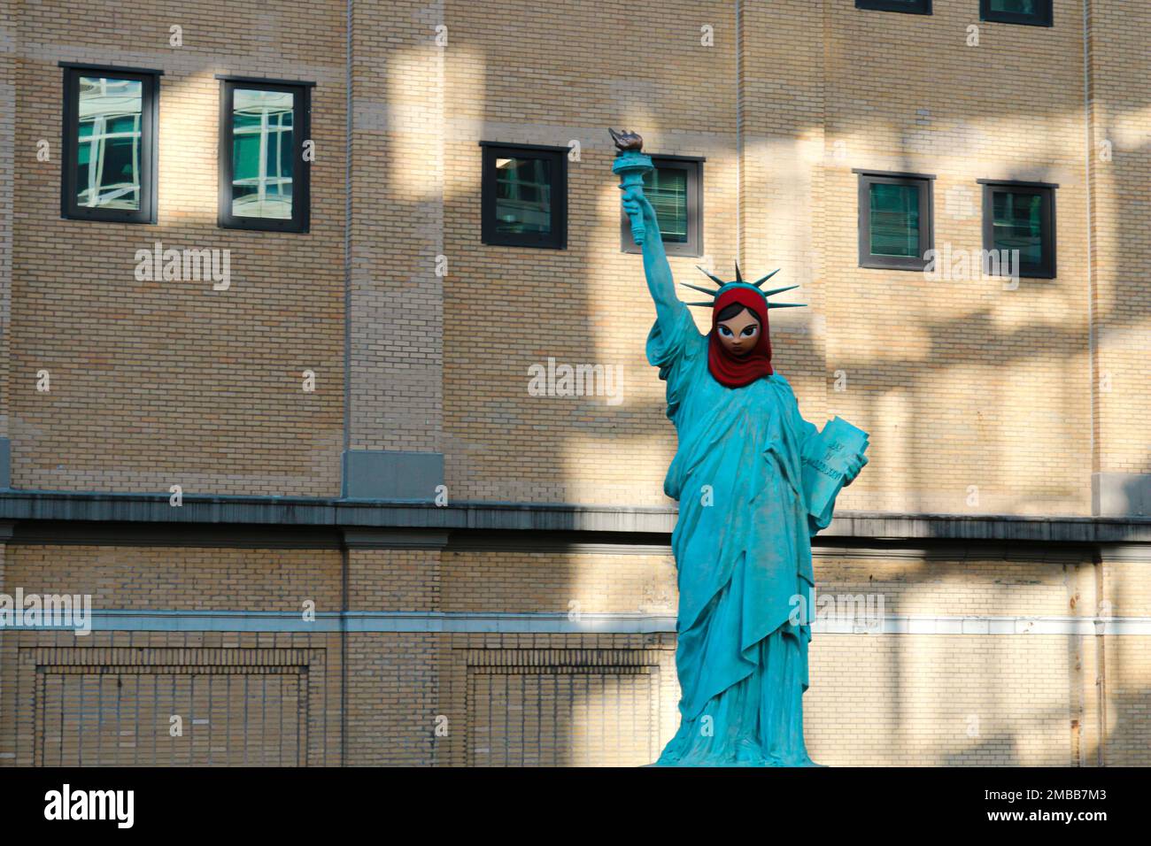 The Statue of Liberty wearing a mask with a stylized face Stock Photo