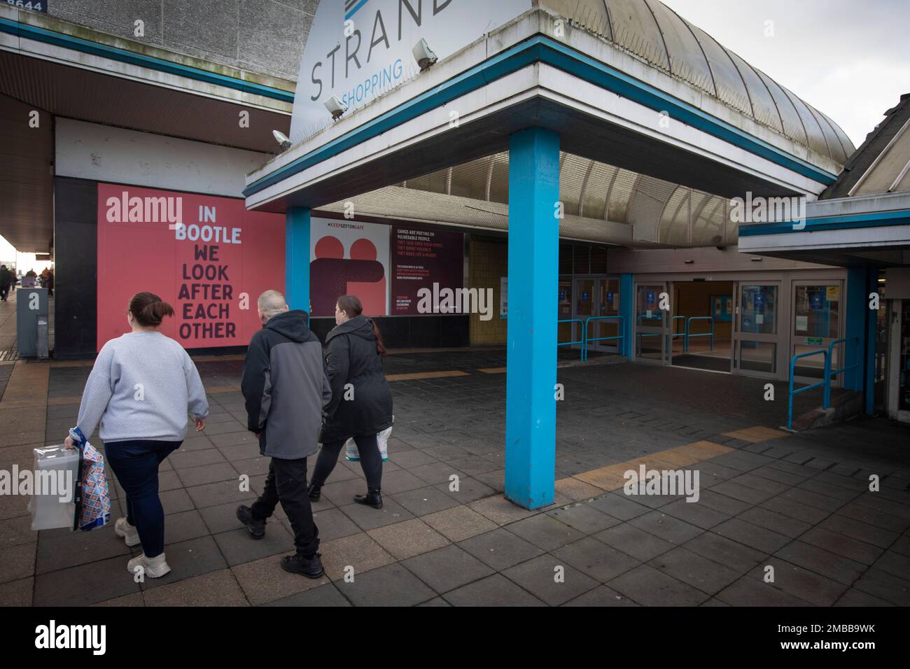 People walking past the entrance to the Strand shopping centre in the town of Bootle, Sefton, which adjoins the city of Liverpool. It was announced in 2015 that the HMRC was set to close its office at Triad House in Bootle, which it was feared would result in job losses in the town. The facility was eventually wound-up in late 2021. Image to illustrate feature on the UK Government’s so-called levelling up agenda. Stock Photo