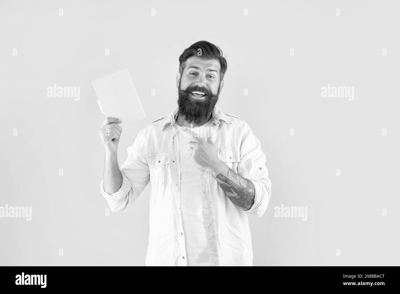 happy bearded man pointing finger on planner on yellow background, daily planning Stock Photo