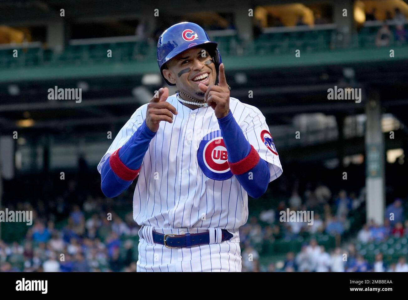 Chicago Cubs' Christopher Morel celebrates toward the dugout after