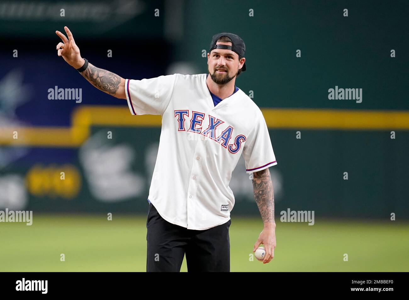 National Hockey League player, Jamie Benn of the Dallas Stars, acknowledges  applause from fans before throwing out the ceremonial first pitch before a  baseball game between the Tampa Bay Rays and Texas
