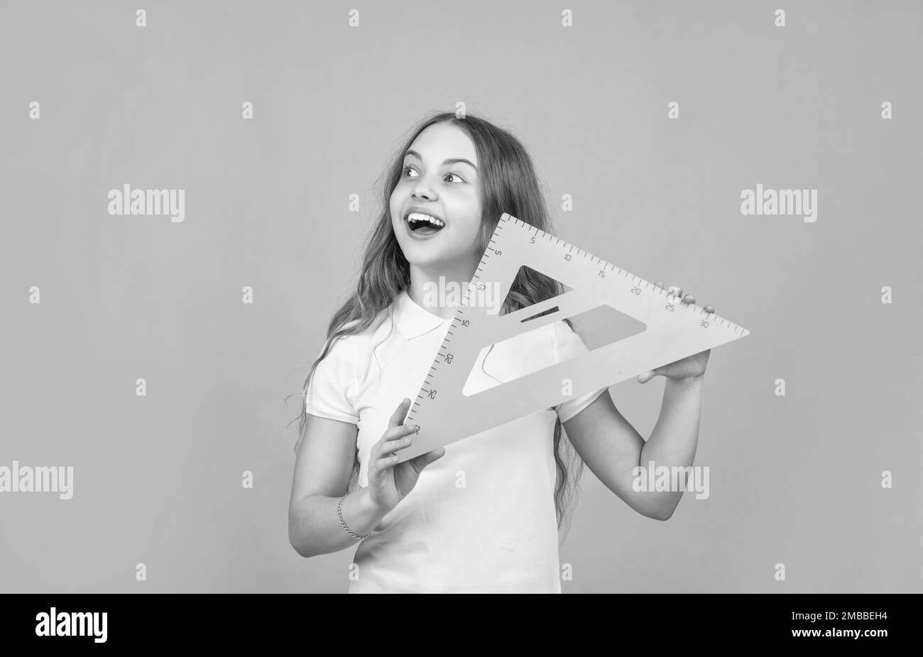 cheerful child with math triangle measuring tool Stock Photo - Alamy
