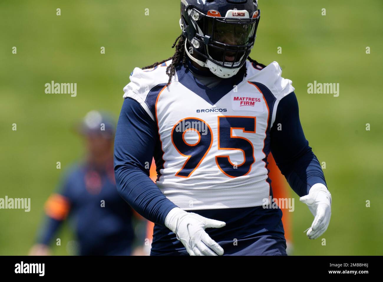 Denver Broncos defensive lineman McTelvin Agim, left, linebacker