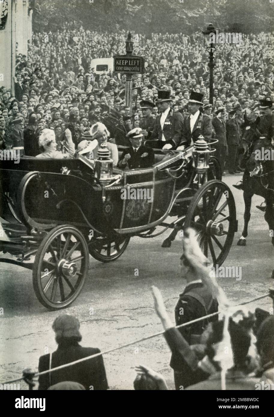 'Victory Drive - 8th June, 1946', 1947. The future Queen Elizabeth II, with her mother Queen Elizabeth and father King George VI, waving at crowds during the London Victory Celebrations after the defeat of of Nazi Germany and Japan in World War II. From &quot;Princess Elizabeth: The Illustrated Story of Twenty-one Years in the Life of the Heir Presumptive&quot;, by Dermot Morrah. [Odhams Press Limited, London, 1947] Stock Photo