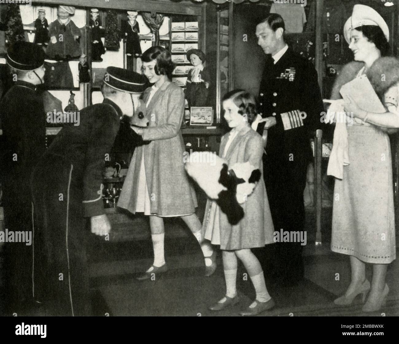 'Welcome Home', 22 June 1939, (1947). King George VI and Queen Elizabeth with daughters Princess Elizabeth (future Queen Elizabeth II) and Princess Margaret Rose. 'When the Princesses greeted their parents on their return from their tour of the United States and Canada...they were presented with toy pandas by members of the crew of the &quot;Empress of Britain&quot;, the ship which had brought the King and Queen back to England'. From &quot;Princess Elizabeth: The Illustrated Story of Twenty-one Years in the Life of the Heir Presumptive&quot;, by Dermot Morrah. [Odhams Press Limited, London, 1 Stock Photo