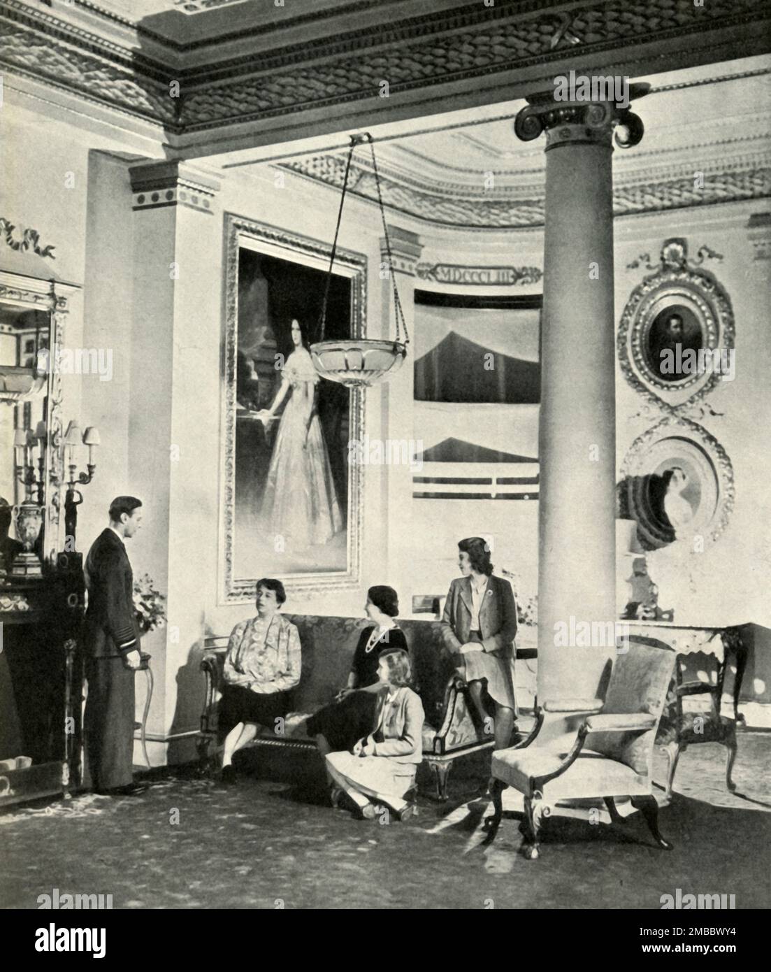 'Mrs. Roosevelt at the Palace', October 1942, (1947). King George VI and Queen Elizabeth with daughters Princess Elizabeth (future Queen Elizabeth II) and Princess Margaret Rose, with US First Lady Eleanor Roosevelt in the Bow Room at Buckingham Palace. From &quot;Princess Elizabeth: The Illustrated Story of Twenty-one Years in the Life of the Heir Presumptive&quot;, by Dermot Morrah. [Odhams Press Limited, London, 1947] Stock Photo