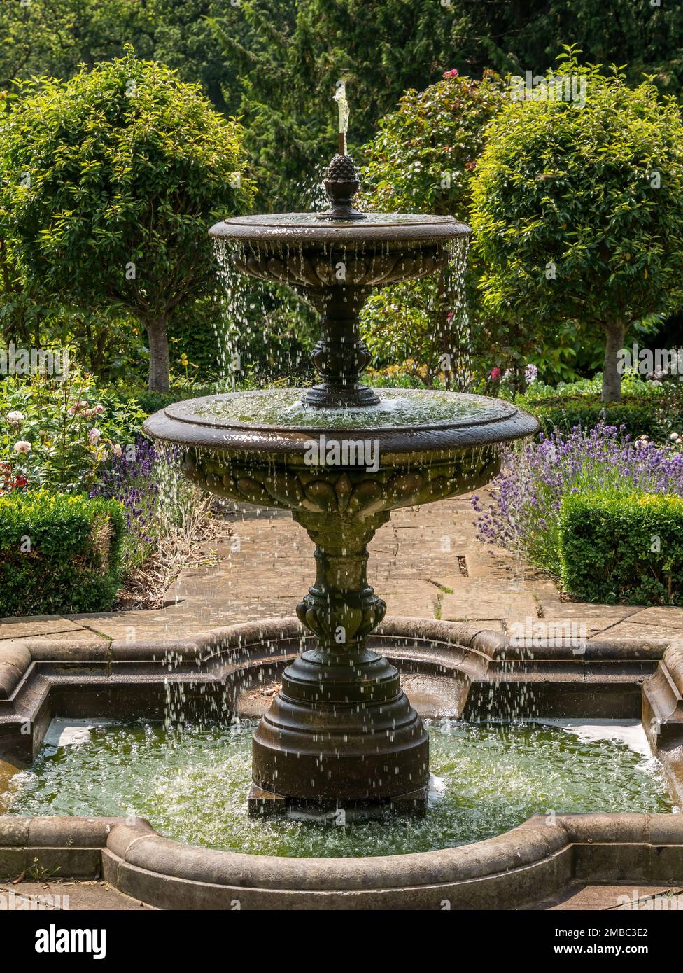Tiered ornamental garden water fountain in the Rose Garden at Belvoir Castle, Leicestershire, England, UK Stock Photo