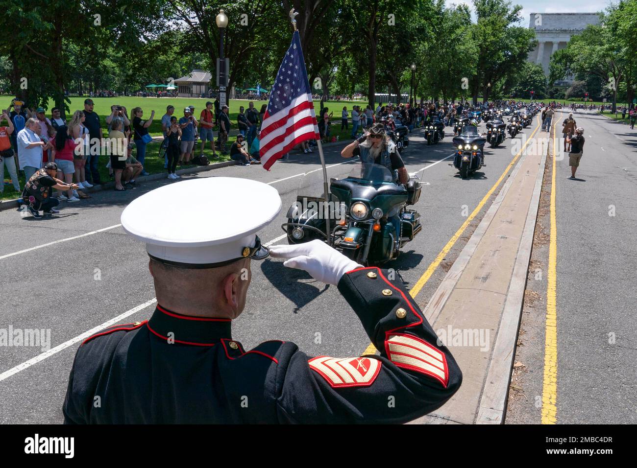 U.S. Marine Corps Staff Sgt. Tim Chambers salutes as participants in ...