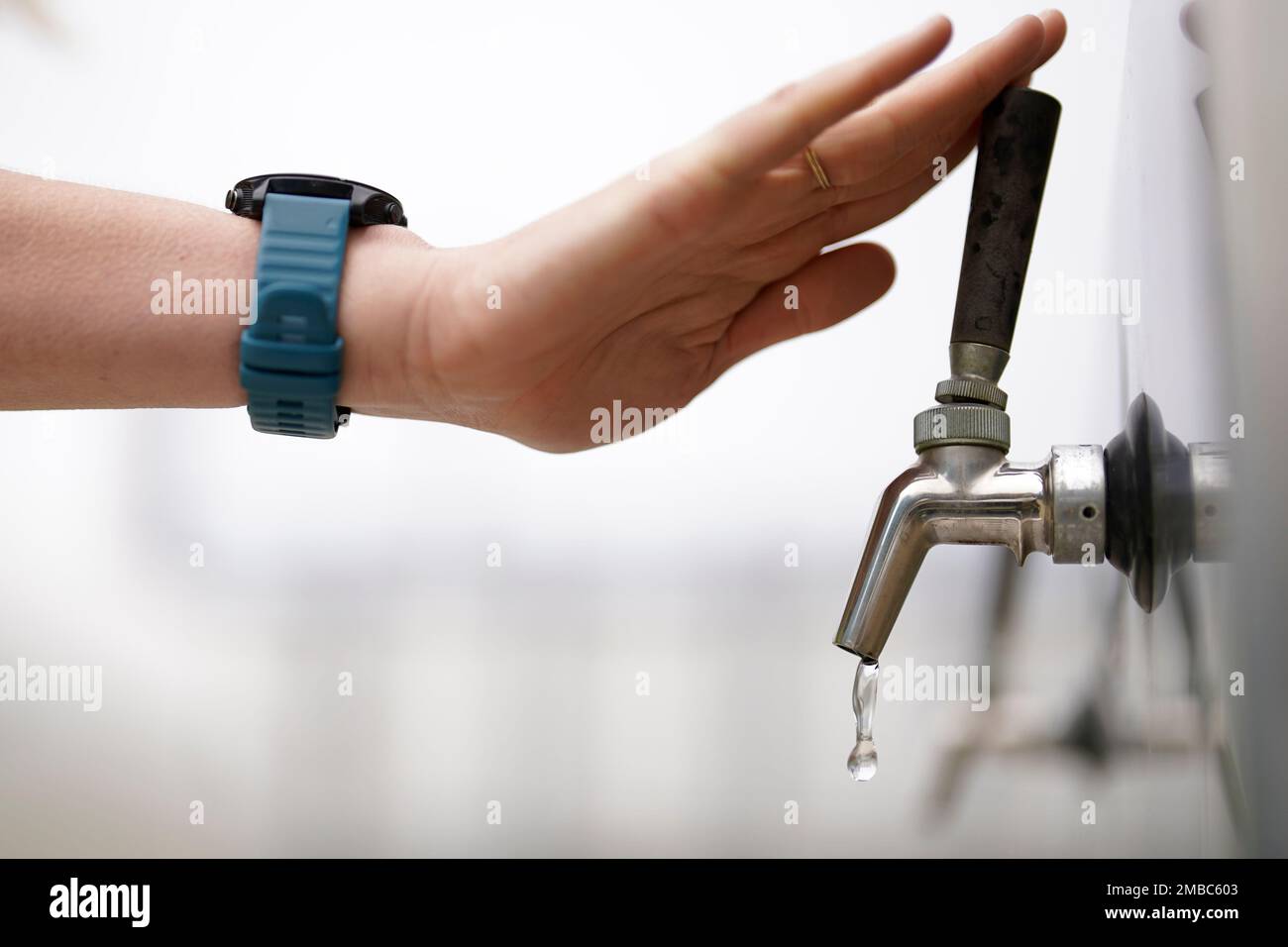 An official at the Carlsbad Desalination plant turns off a spigot of