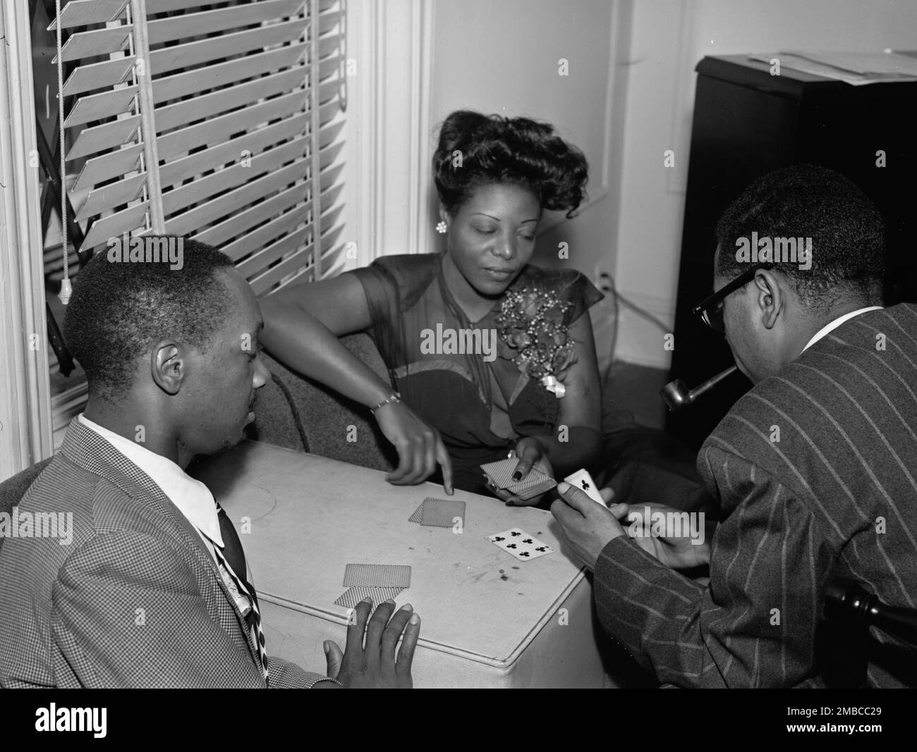 Portrait of Tadd Dameron, Mary Lou Williams, and Dizzy Gillespie, Mary Lou Williams' apartment, New York, N.Y., ca. Aug. 1947. Stock Photo