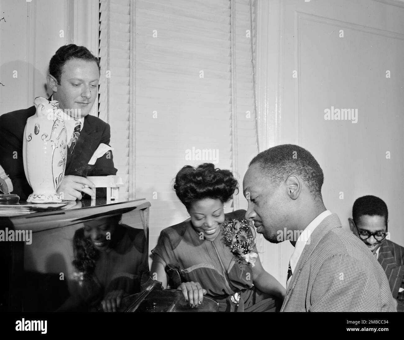 Portrait of Milt Orent, Mary Lou Williams, Hank Jones, and Dizzy Gillespie, Mary Lou Williams' apartment, New York, N.Y., ca. Aug. 1947. Stock Photo