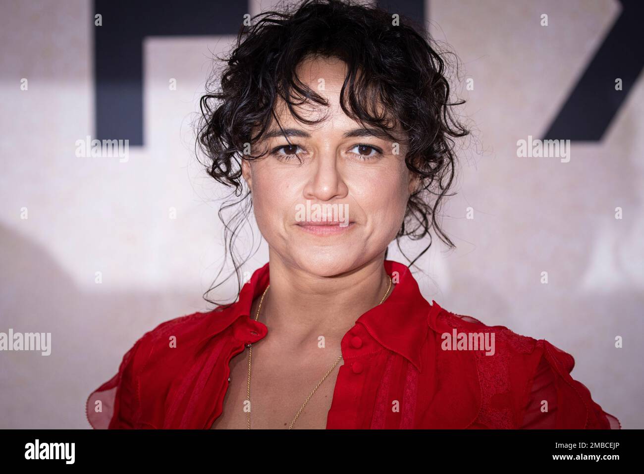 Michelle Rodriguez poses for photographers upon arrival at the amfAR