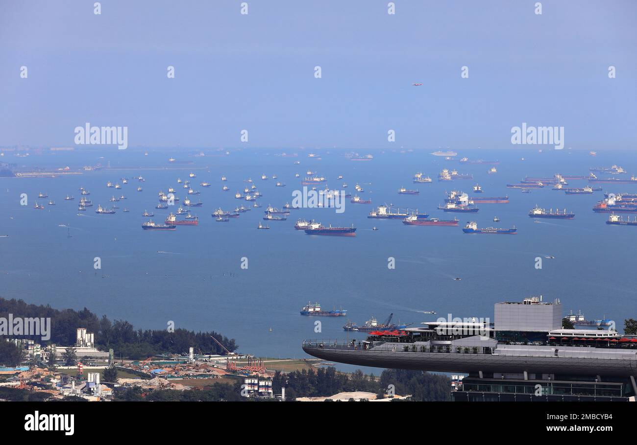Aerial view of ocean liner and Cargo Ship in Singapore Strait as a background of Marina Bay Sands Singapore building. Stock Photo