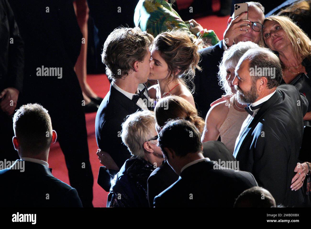 Austin Butler, left, and Kaia Gerber kiss on the red carpet after