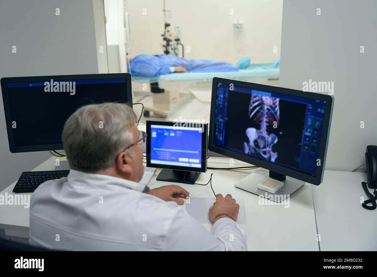 Male diagnostician performs a CT scan using modern equipment Stock Photo Alamy