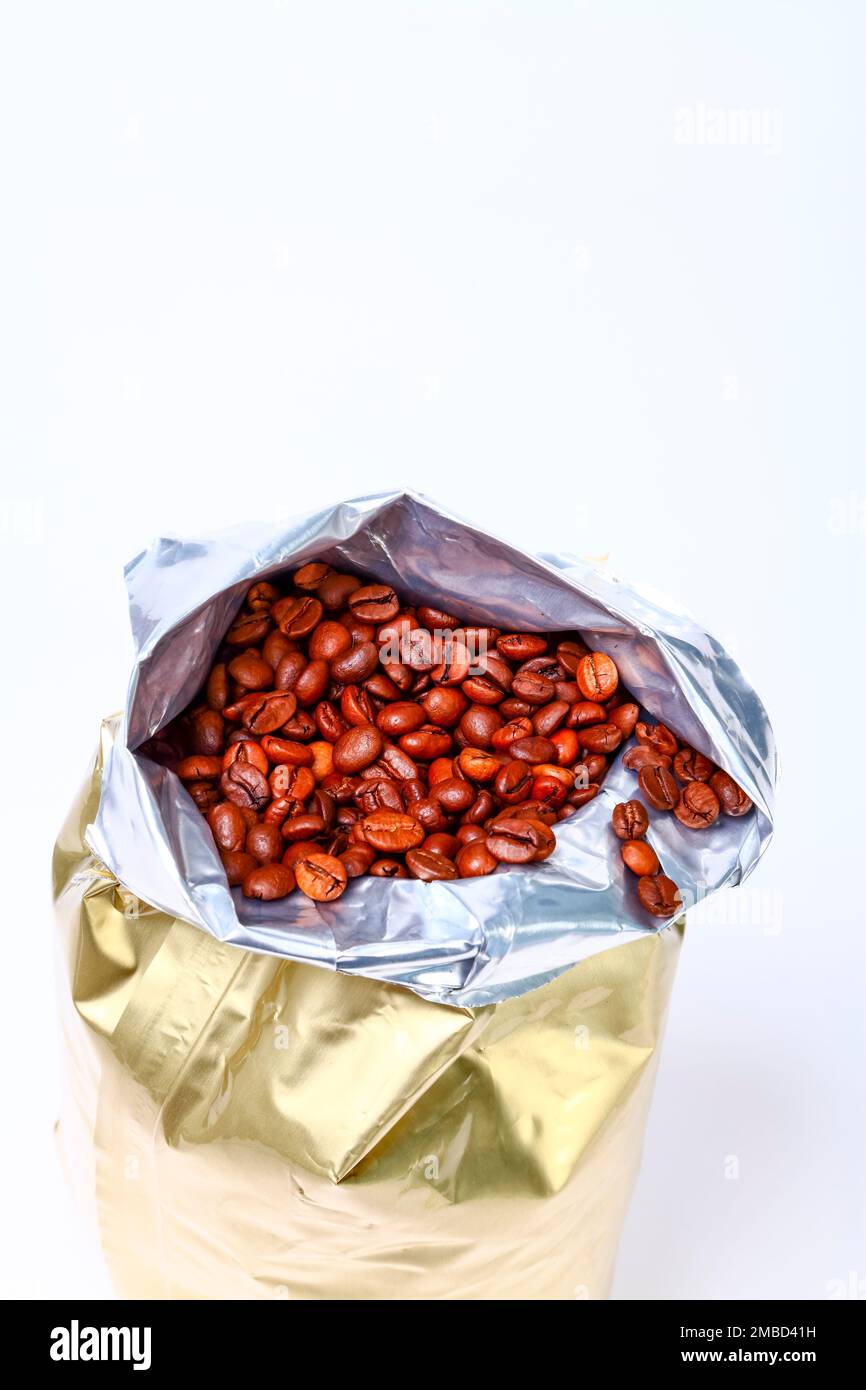 Foil fresh bag full of espresso roasted coffee beans isolated on a white background with copy space Stock Photo