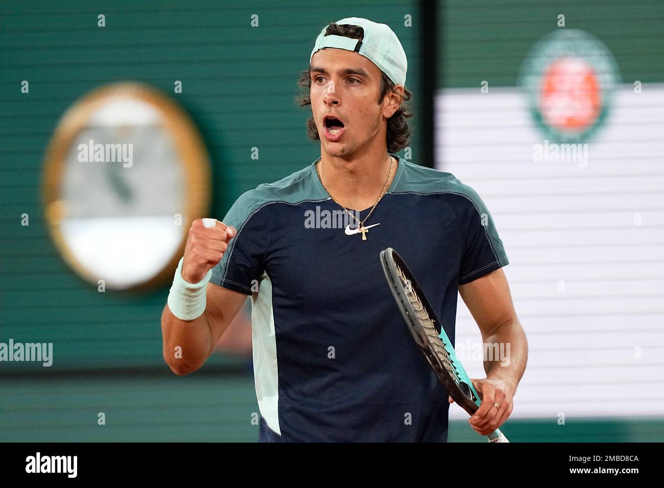Italys Lorenzo Musetti celebrates winning a point as he plays Greeces Stefanos Tsitsipas during their first round match of the French Open tennis tournament at the Roland Garros stadium Tuesday, May 24,