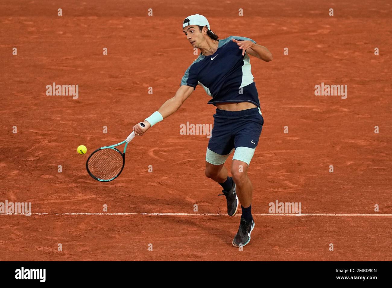 Italys Lorenzo Musetti returns the ball to Greeces Stefanos Tsitsipas during their first round match of the French Open tennis tournament at the Roland Garros stadium Tuesday, May 24, 2022 in Paris