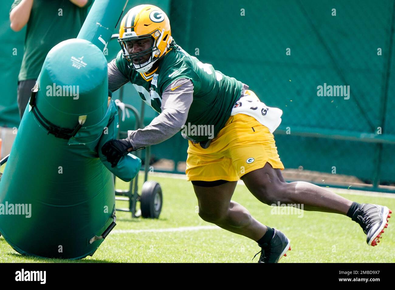 Green Bay Packers' T.J. Slaton runs a drill at the NFL football