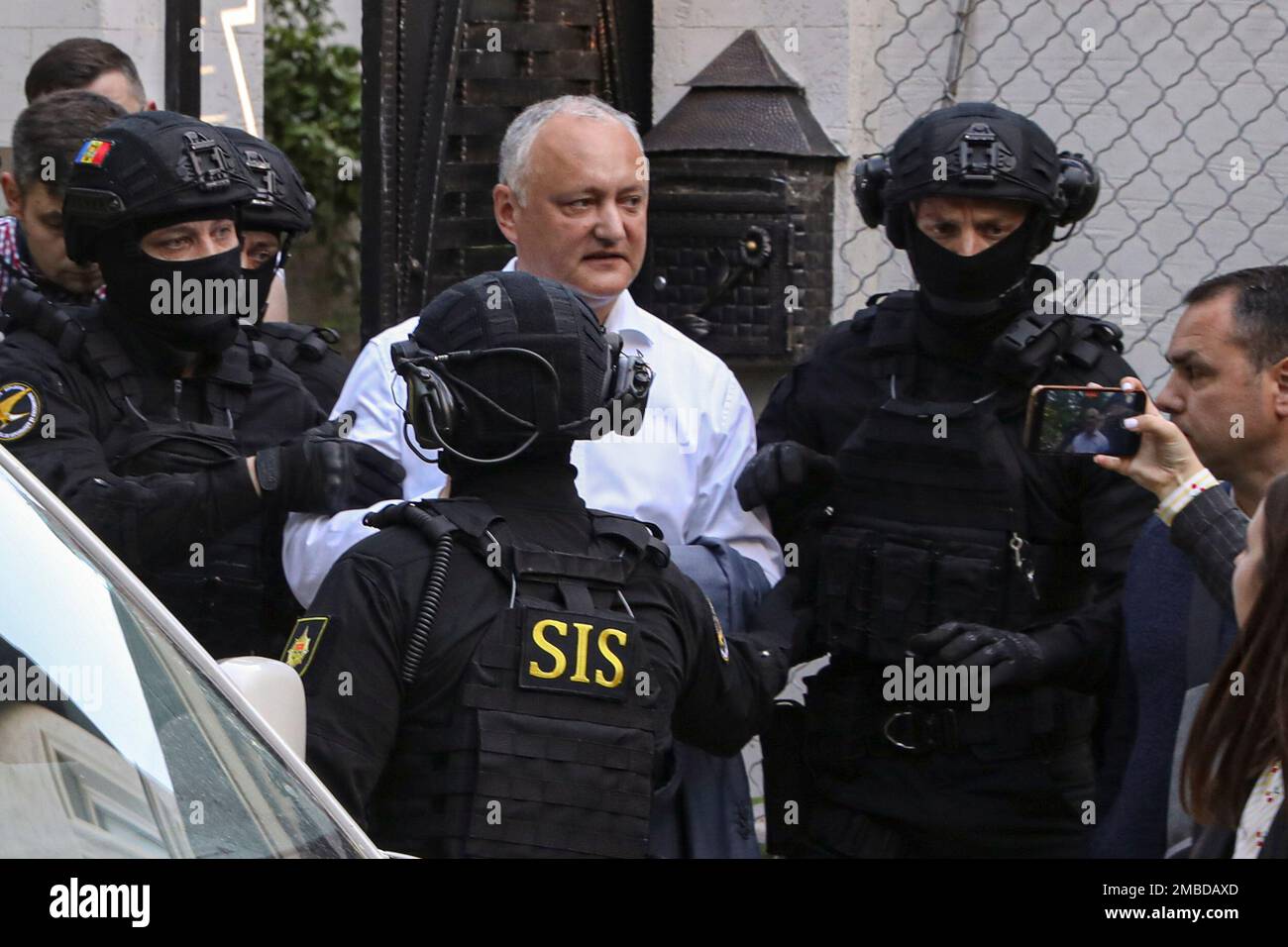 Members of Moldova's Information and Security service (SIS) escort former  Moldovan President Igor Dodon to a van after he was detained at his house  in Chisinau, Moldova, Tuesday, May 24, 2022. Moldovan
