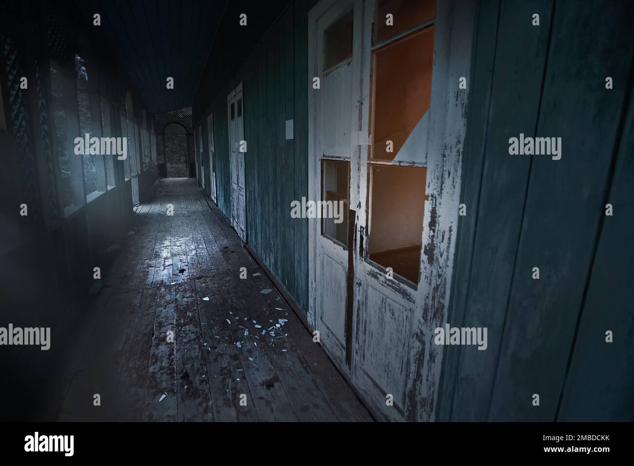 Lost place. Abandoned sanatorium decomposes with time. Broken doors, broken windows. Long corridor. High quality photo Stock Photo