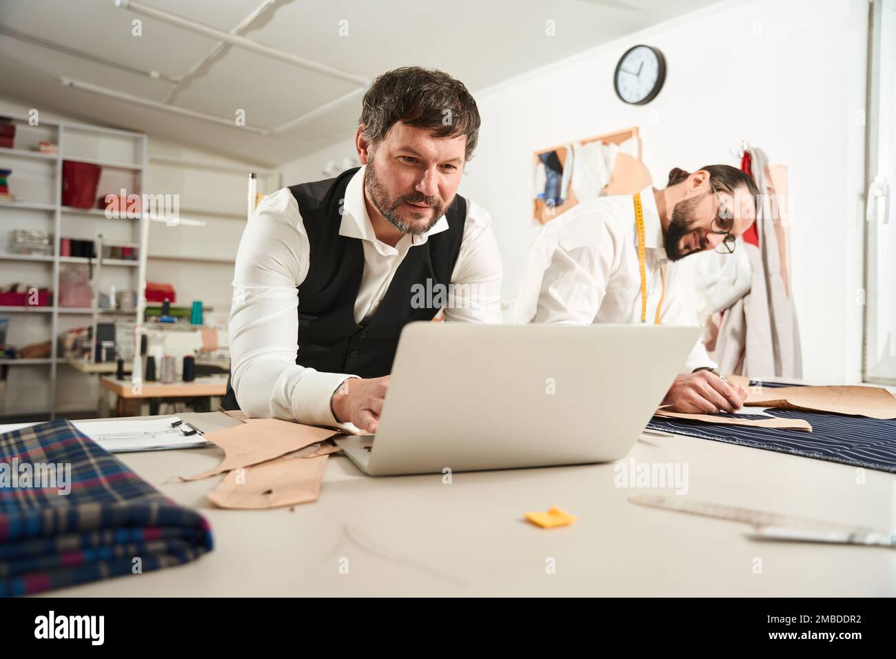 Two colleagues working together in sewing workshop Stock Photo