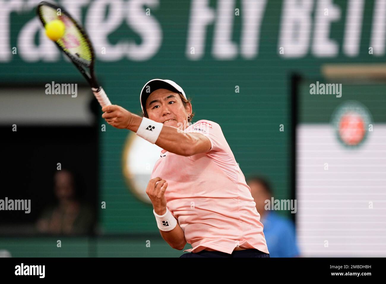 Japans Yoshihito Nishioka plays a shot against Serbias Novak Djokovic during their first round match at the French Open tennis tournament in Roland Garros stadium in Paris, France, Monday, May 23, 2022