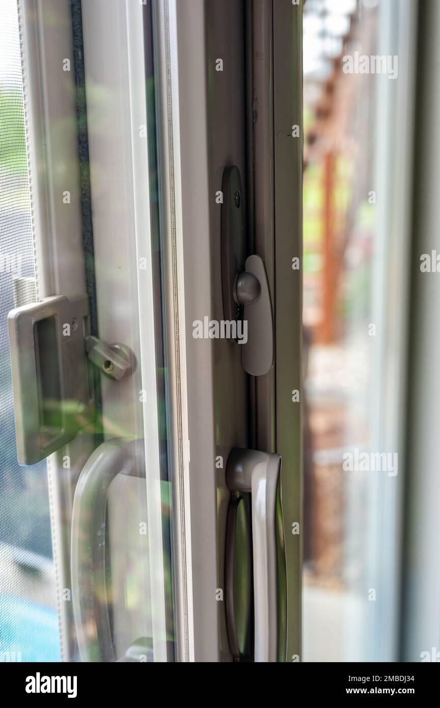 Handle, locking hardware, and jam to a sliding glass and screen door