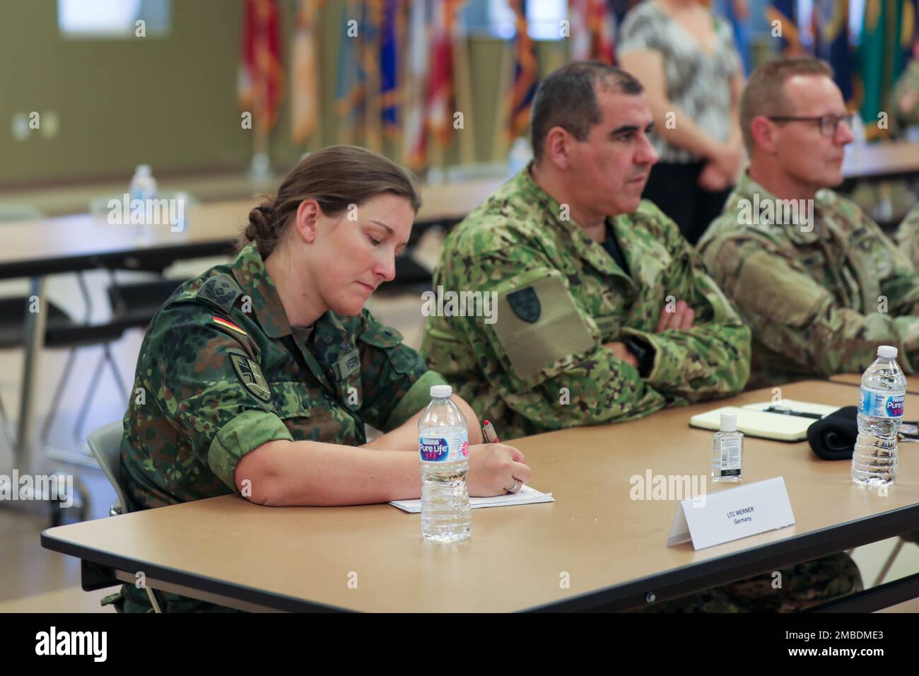 Lt. Col. Hekja Marlen Werner, Assistant Military Attaché, Germany, takes  notes during a U.S. Army Civil Affairs and Psychological Operations Command  (Airborne) capabilities briefing held June 14, 2022, at Fort Bragg, North