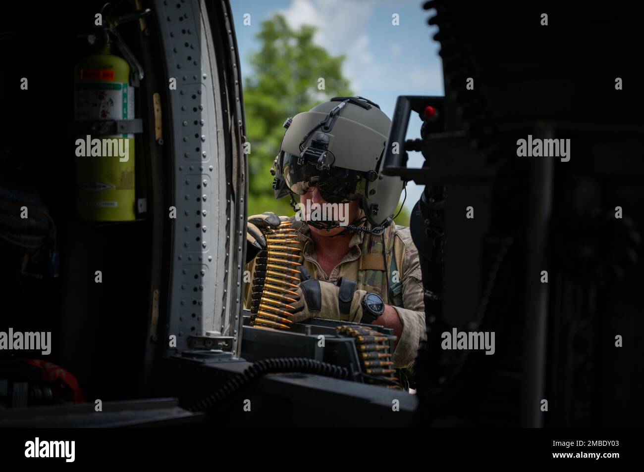 Master Sgt. Will Towers, 301st Rescue Squadron special mission aviator evaluator, loads a GAU-2 7.62 mm minigun during a turkey shoot competition at Avon Park Air Force Range, Florida, June 14, 2022. During the competition aircrew members competed on skills such as aircraft weapons employment, helicopter air to air refueling, degraded navigation, degraded search, and confined hoisting. Stock Photo