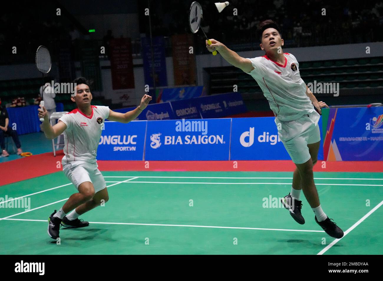 Indonesias Pramudya Kusumawardana, left, and Yeremia Rambitan compete against their compatriots Leo Rolly Carnando and Daniel Marthin during their mens doubles badminton final match at the 31st Southeast Asian Games (SEA Games)