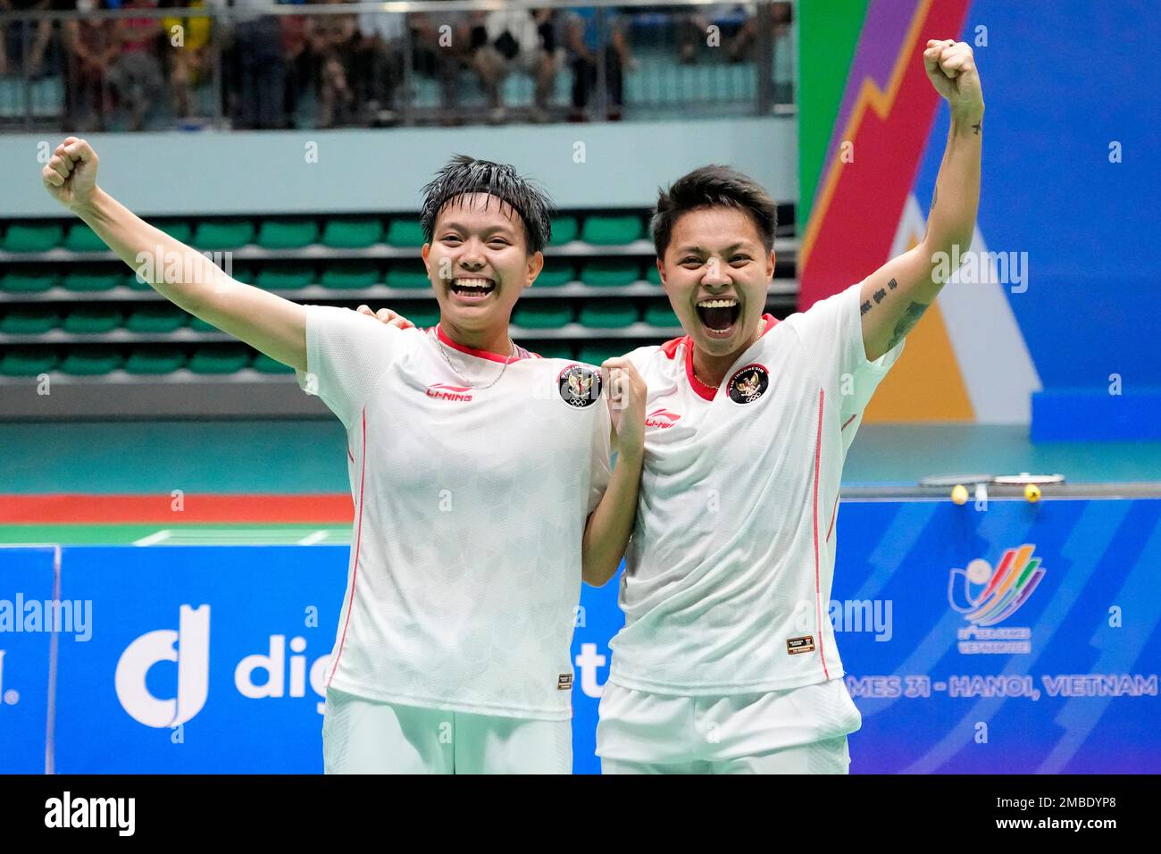 Indonesias Apriyani Rahayu, right, and Siti Fadia Silva Ramadhanti celebrate after defeating Thailands Benyapa Aimsaard and Nuntakarn Aimsaard during their womens doubles badminton final match at the 31st Southeast Asian Games (SEA