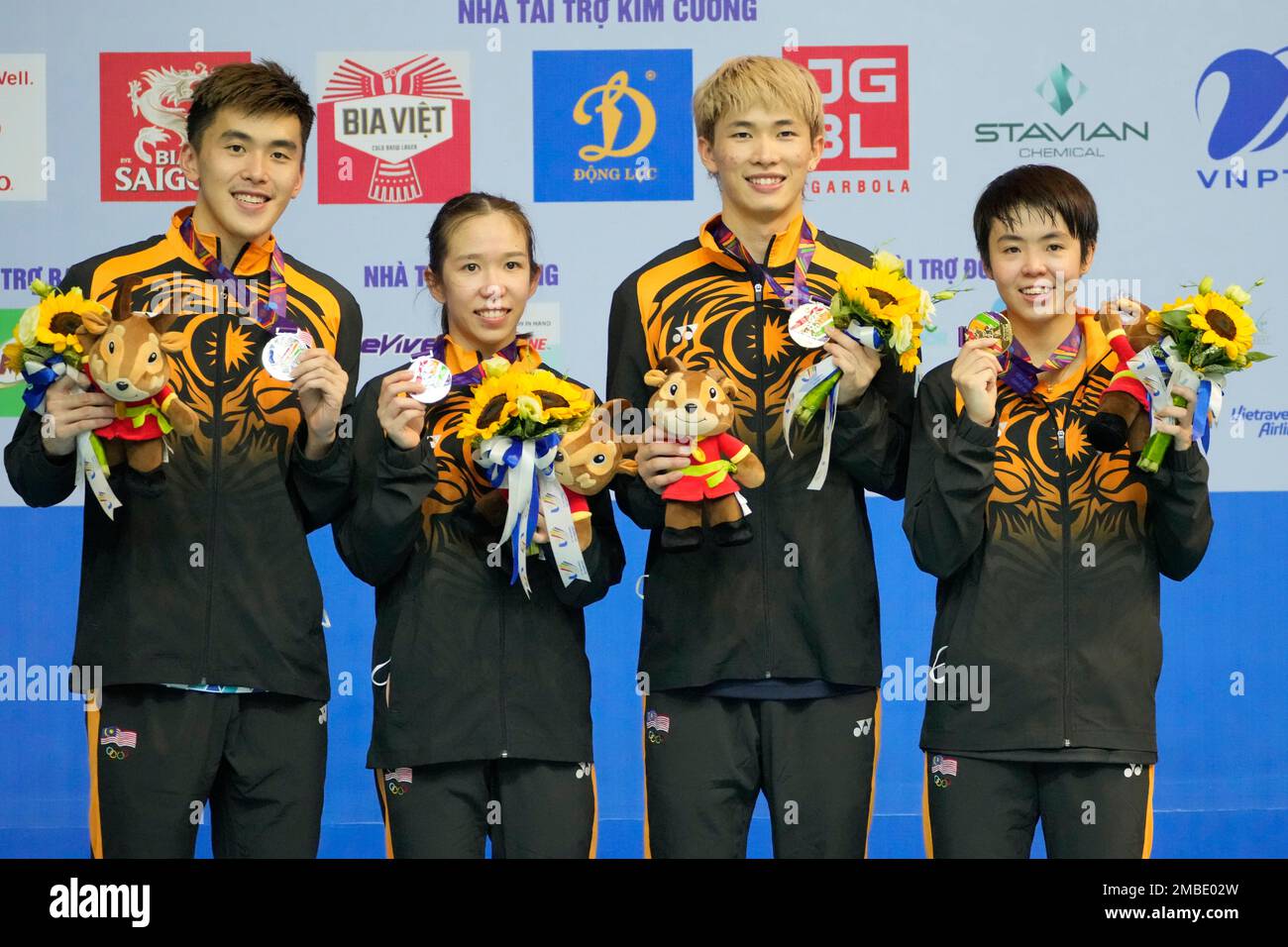 Gold medalists, Chen Tang Jie, second right, and Peck Yen Wei, right, celebrate with tsilver medalists Hoo Pang Ron, left and Cheah Yee See, all from Malaysia, during the victory ceremony for