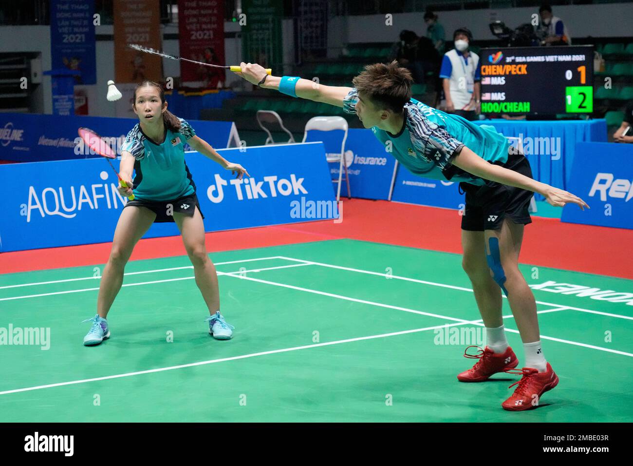 Malaysias Hoo Pang Ron, right, and Cheah Yee See compete against their compatriots Chen Tang Jie and Peck Yen Wei during their mixed doubles badminton final match at the 31st Southeast Asian