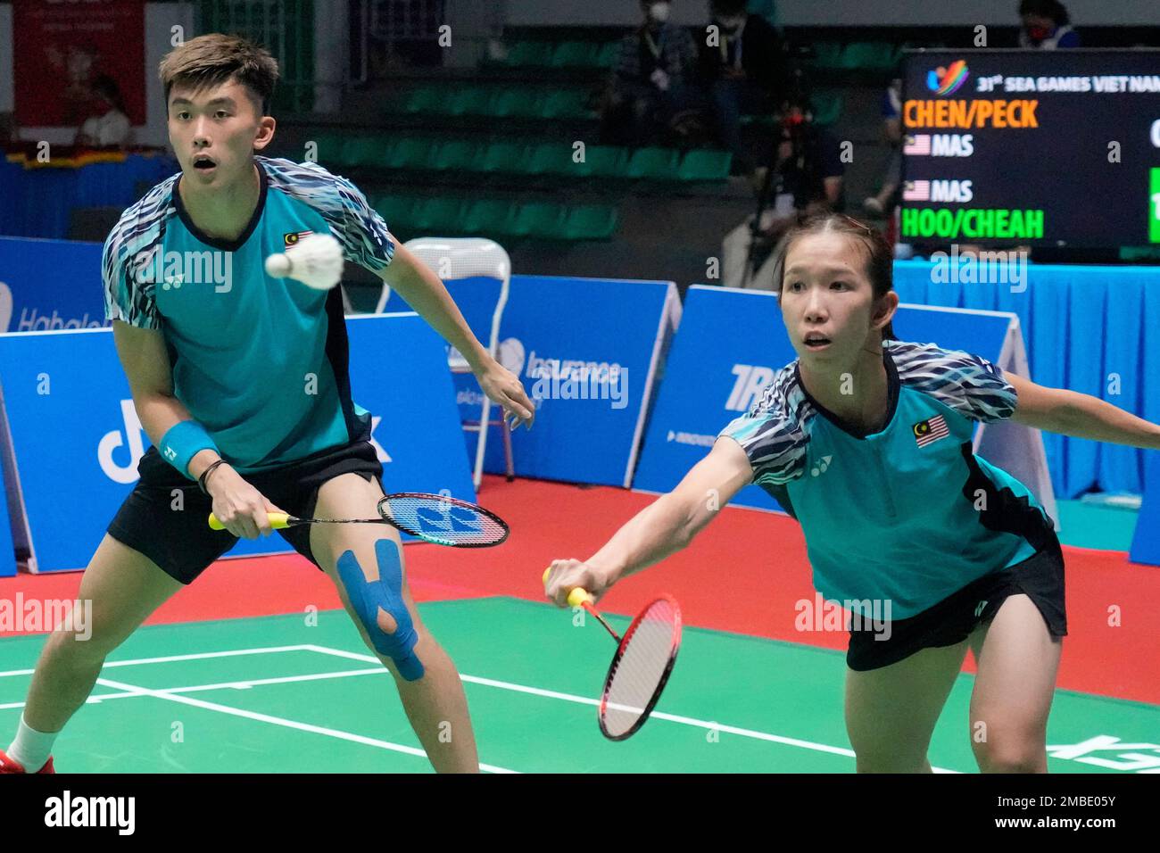 Malaysias Hoo Pang Ron and Cheah Yee See, right, compete against their compatriots Chen Tang Jie and Peck Yen Wei during their mixed doubles badminton final match at the 31st Southeast Asian