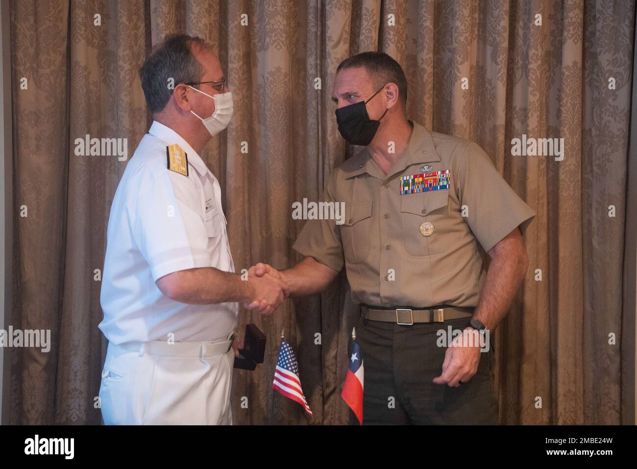 U.S. Marine Corps Brig. Gen. Joseph R. Clearfield, deputy commander, U.S. Marine Corps Forces, Pacific, shakes hands with Chilean Navy Vice Adm. Pablo Niemann, general directorate of logistics, during a bilateral meeting at the eighth iteration of the Pacific Amphibious Leaders Symposium, Tokyo, Japan, June 15, 2022. PALS consists of discussions and presentations which facilitate meaningful dialogue on key aspects of amphibious operations, capability development, crisis response and interoperability. This year’s symposium brought together senior leaders from 18 participating delegations who ar Stock Photo
