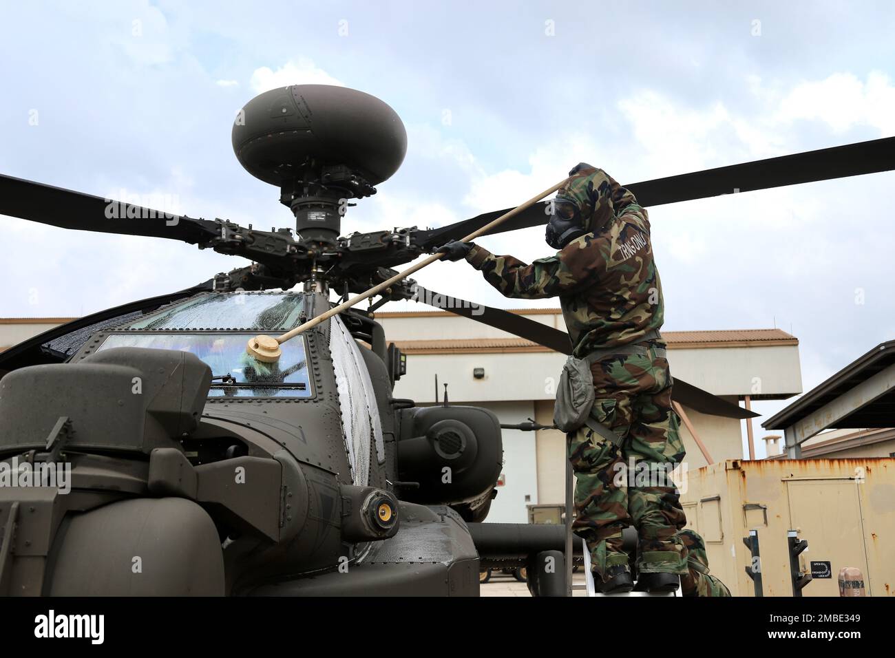 Soldiers from 23rd Chemical Battalion, 2nd Infantry Division Sustainment Brigade lead a class on decontamination of an AH-64E v6 Apache helicopter. The Soldiers from 4-2 Attack Battalion, 2nd Combat Aviation Brigade were able to get a hands on experience of using the M26 decontamination apparatus to spray down the helicopter. Stock Photo